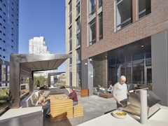 Thumbnail of The Ashland: 41P a man sitting in front of a building
