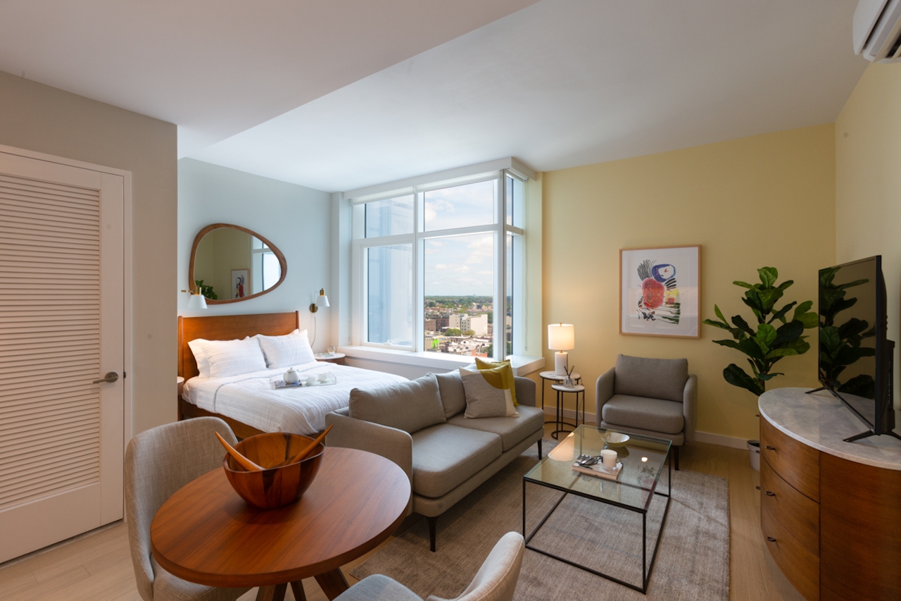 a living room filled with furniture and a large window