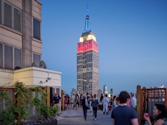 Thumbnail of Atlas New York: 44C a group of people walking in front of a tall building